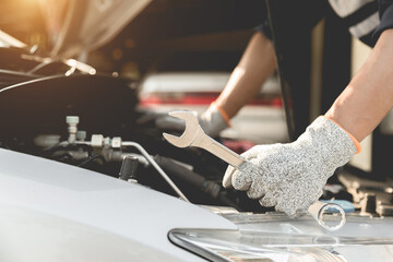 Automobile mechanic repairman hands repairing a car engine automotive workshop with a wrench, car service and maintenance,Repair service.