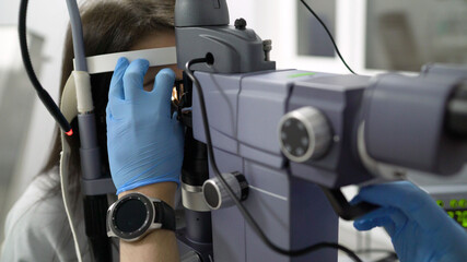 Ophthalmology operation. Surgeon's hands performing laser eye vision correction or cataract...