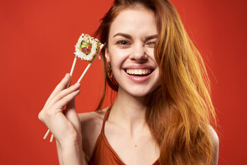 cheerful red-haired woman sushi rolls diet fun close-up