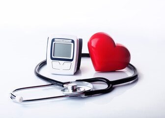 stethoscope, tonometer and heart on white background