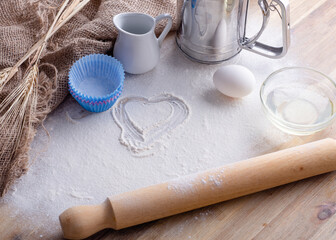 baking ingredients egg, flour, oil for baking on wooden background 