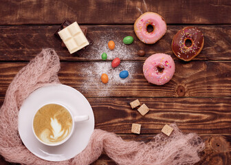 Fototapeta na wymiar cup of coffee, cookies, doughnut, sweets, chocolates on wooden background 