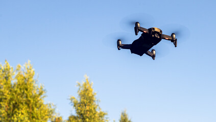 a quadrocopter with a video camera flies over the forest