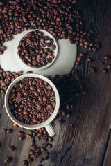 Hot drink in a saucer and sprinkled grain on a wooden table top view