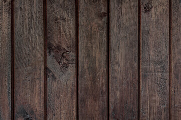Texture of rural stained exterior vertical oak planks of country shed. Old dirty rough siding of gnarled surface wooden paneling. Rustic veined facing lumber fence of hard boards for 3D style design