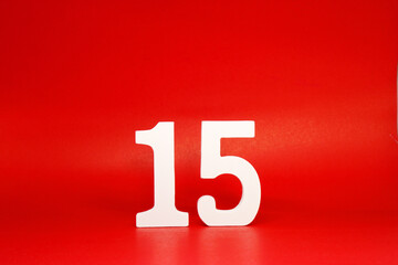 Fifteen ( 15 ) white number wooden Isolated Red Background with Copy Space - New promotion 15% Percentage  Business finance Concept 