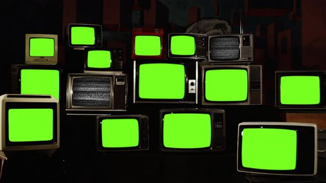 Stack of Retro Vintage TV Turning On Green Screens. You can replace green screen with the footage or picture you want. You can do it with “Keying” effect in After Effects. 4K Resolution.