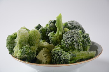 Small frozen  broccoli pieces.  Healthy food. Frozen vegetables