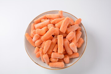 Small frozen carrots pieces.  Healthy food. Frozen vegetables