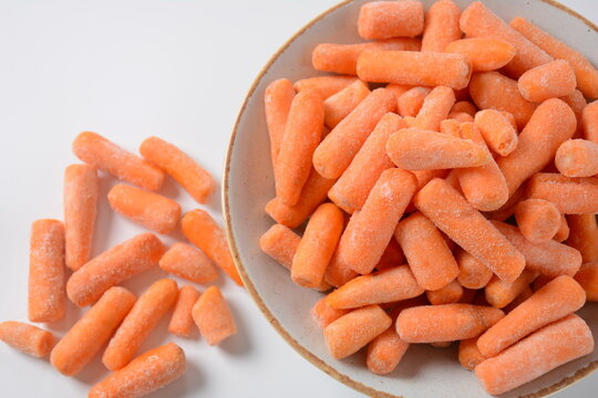 Small frozen carrots pieces.  Healthy food. Frozen vegetables