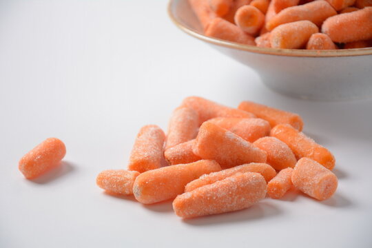 Small frozen carrots pieces.  Healthy food. Frozen vegetables