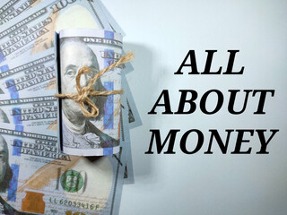 Selective focus.Word ALL ABOUT MONEY with dollar banknote on white background.Business concept.