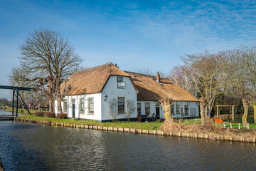 Traditional Dutch farmhouse along a cannel