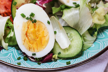 Healthy salad with lettuce, tomatoes and eggs.