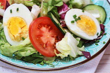 Healthy salad with lettuce, tomatoes and eggs.