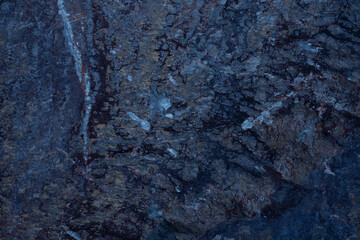 black stone background with bluish veins. texture