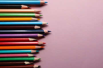 Color pencils set, row wooden color pencils isolated on pink background. colored pencils for drawing. copy space.