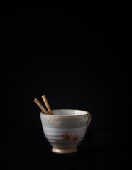 Traditional, handcrafted ceramic on dark background. Soft focus. Close up.