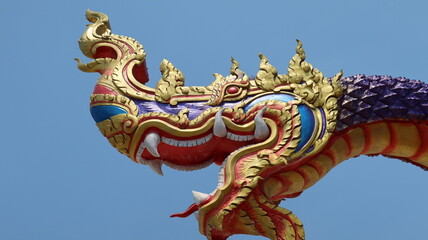 Fototapeta na wymiar Mythical Naga soaring into blue sky