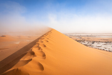 Fototapeta na wymiar The desert dunes on a sunny and windy day, Deadvlei, Sossusvlei, Namibia, Africa.