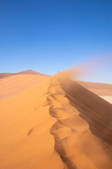 The desert dunes on a sunny and windy day, Deadvlei, Sossusvlei, Namibia, Africa.