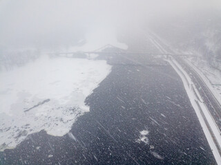 The frozen Dnieper river in Kiev in a snowstorm, blizzard. Aerial drone view. Winter snowy morning.