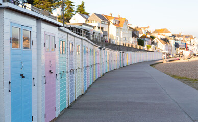 Fototapeta na wymiar A row of closed and locked up beach huts with no holidaymakers