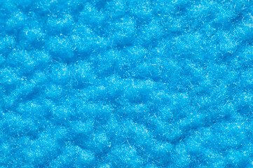Warm warming fabric based on blue fleece material close-up, macro
