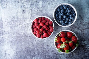 Fresh ripe blueberry,  strawberry, raspberry in a white bowl