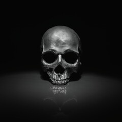 Spooky dark black skull aginast dark background