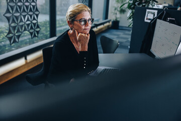 Fototapeta na wymiar Thoughtful senior businesswoman at her desk