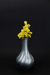 yellow flowers in a black vase