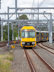 Commuter train approaching train station in Sydney NSW Australia