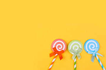 Colorful Cupcake Topper Paper Lollipops With Straw on bright yellow background