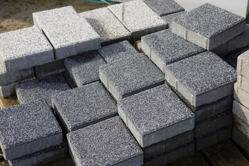Pavement-Stacks of new concrete paving slabs on wooden pallets
