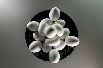 White easter eggs on black plate