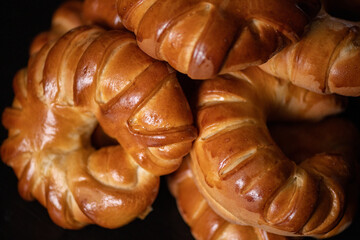 Homemade bagels close-up on a dark wooden background.