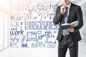 Businessman with notebook and sketch with plan on background