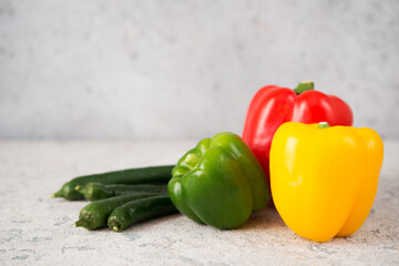 Fresh juicy bell peppers on a gray background