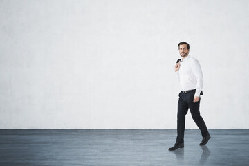Fototapeta premium Handsome businessman in white shirt holding his jacket is walkin