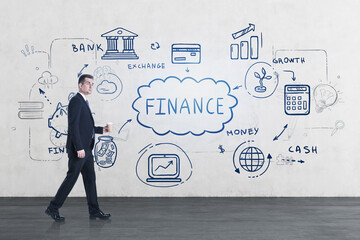 Businessman in black suit and financial plan on a wall in office