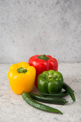 Fresh juicy bell peppers on a gray background
