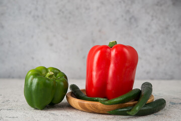 Fresh juicy bell peppers on a gray background, close up