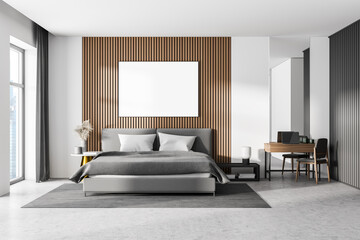 White bedroom interior with concrete floor, a large window, a gray bed and two bedside tables. A cabinet with mirrors. Poster on wooden wall. mock up