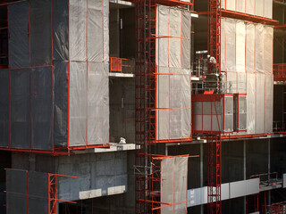 Elevator used for worker and moving materials at, Construction site, Engineer inspecting passenger lift system, Development land and residential building in urban.