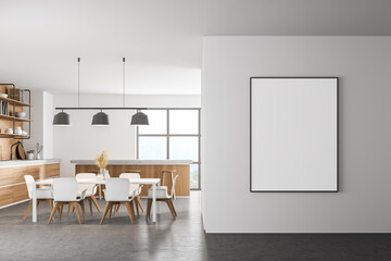 White modern kitchen interior. Dining area with wooden table. Concrete floor. Panoramic window. Mock up poster on wall.