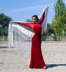 Fototapeta na wymiar Flamenco dancer with red dress and manton de manila