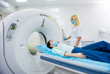 Radiologist with a female patient in the room of computed tomography - obrazy, fototapety, plakaty