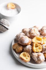 Making Bunuelos, spanish small  deep fried doughs  on white background..