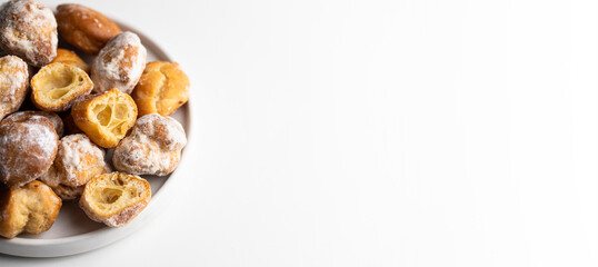 Plate with Bunuelos, Small  deep fried doughs in ceramic ball  with sugar on large background for banner.